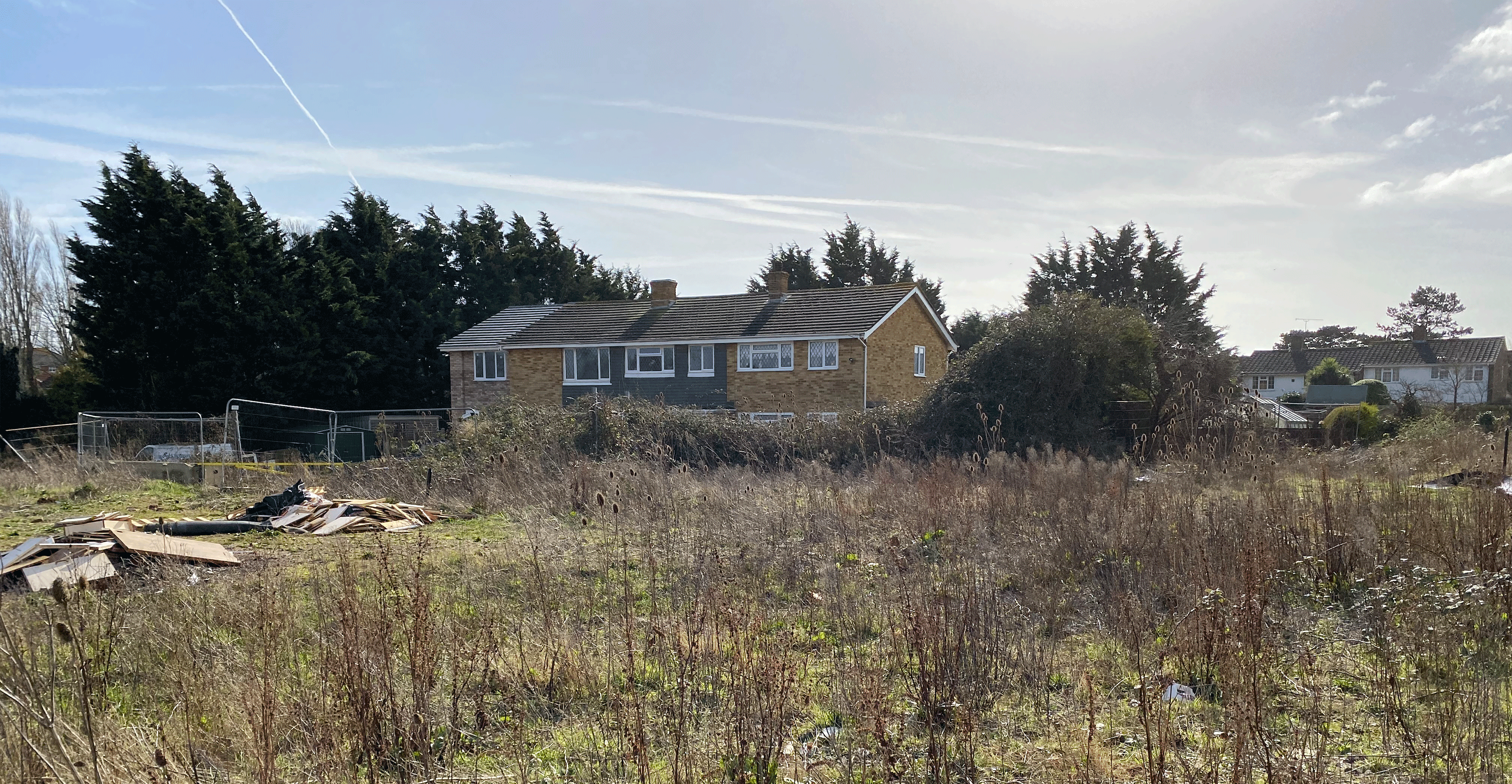 Existing site photo showing site entrance and Toddington Farm Cottages from the northwest